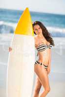 Woman holding surfboard at the beach