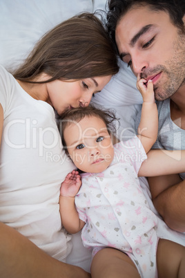 Close-up of family lying on bed