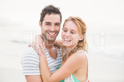 Young couple embracing each other on the beach