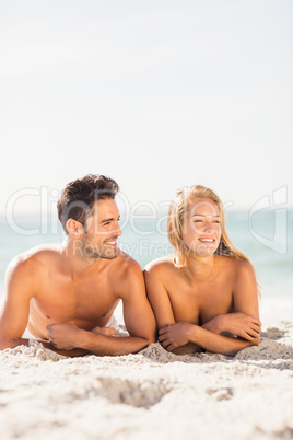 Young couple lying on sand