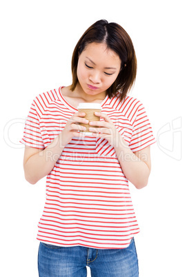 Happy young woman holding disposable cup