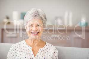 Portrait of senior woman sitting on sofa