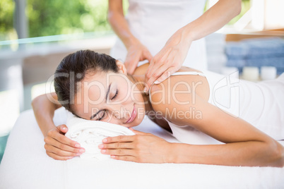 Side view of woman receiving back massage