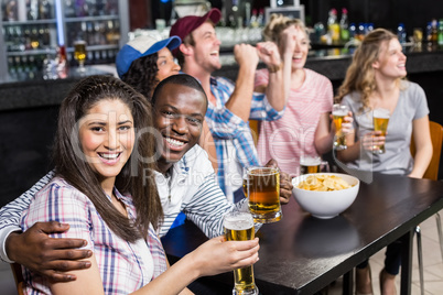 Happy friends watching sport