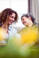 Mother and daughter sitting in living room