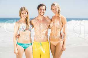 Young friends standing on the beach