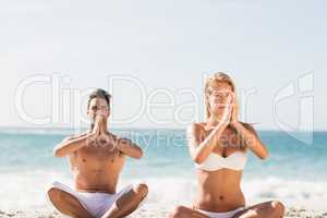 Happy couple doing yoga