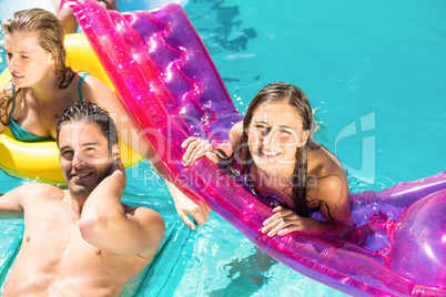 Happy friends enjoying in the swimming pool