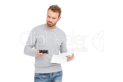 Young man calculating bill