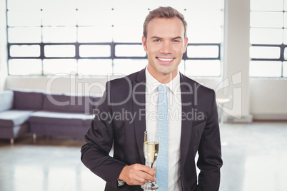 Portrait of businessman holding champagne flute