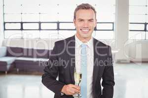 Portrait of businessman holding champagne flute