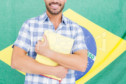 Mid section of happy young man holding folder