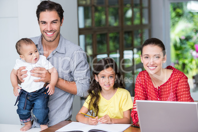 Smiling family at desk