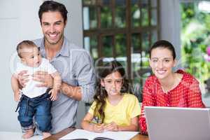 Smiling family at desk