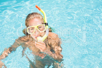 Portrait of woman with snorkel gear swimming in pool