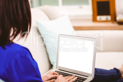 Rear view of woman using laptop