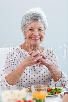 Elderly woman having breakfast