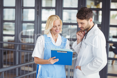 Female doctor discussing with male colleague