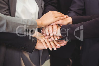 Close-up of businesspeople stacking hands