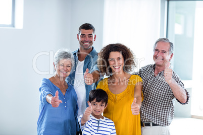 Portrait of happy family showing their thumbs up