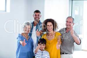 Portrait of happy family showing their thumbs up