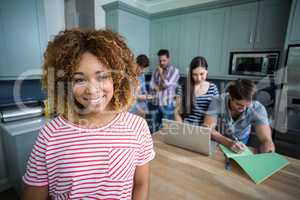 Portrait of smiling young woman with friends in background