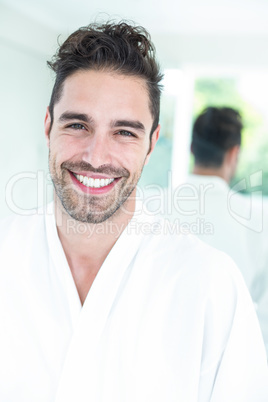 Happy handsome man against mirror