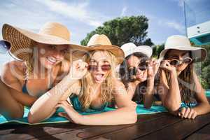 Happy friends enjoying at the swimming pool