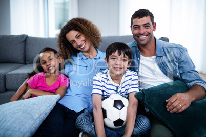 Portrait of family watching match together on television