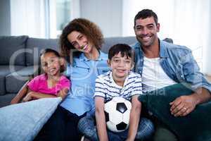 Portrait of family watching match together on television