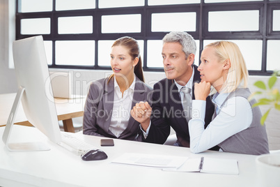 Business professionals working at computer desk