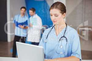 Female doctor working on laptop