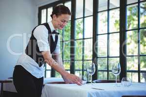 Waitress setting the table