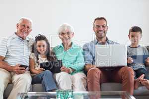 Happy family sitting on sofa