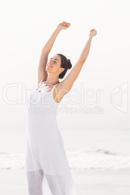 Beautiful woman stretching on the beach