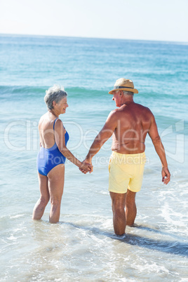 Senior couple walking on the water
