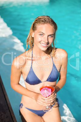 Beautiful young woman having cocktail