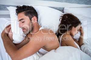 Couple sleeping on bed