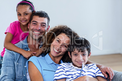 Portrait of happy family sitting together on sofa