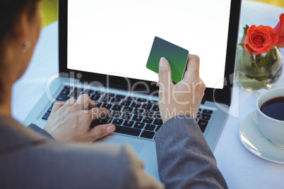 Businesswoman using her credit card to buy online