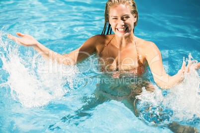 Beautiful woman enjoying in swimming pool