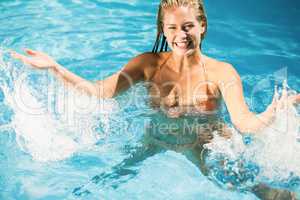 Beautiful woman enjoying in swimming pool