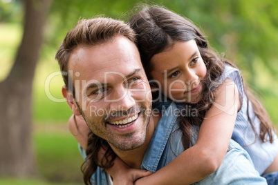 Young girl rides piggyback