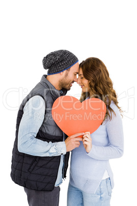 Happy young couple holding heart