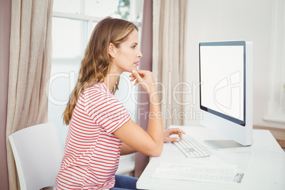 Beautiful woman using computer at home