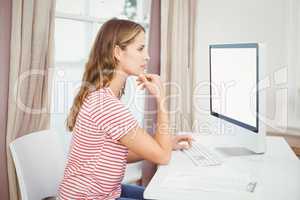 Beautiful woman using computer at home