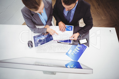 Business people discussing over documents