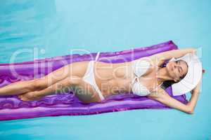 Seductive young woman relaxing on inflatable raft