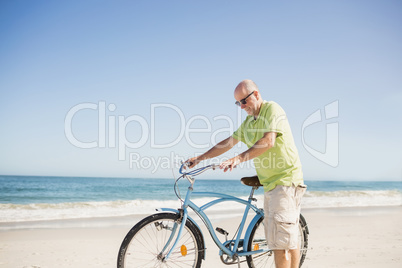 Smiling senior man with bike