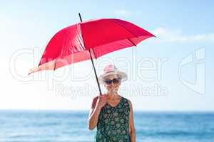 Senior woman posing with an umbrella